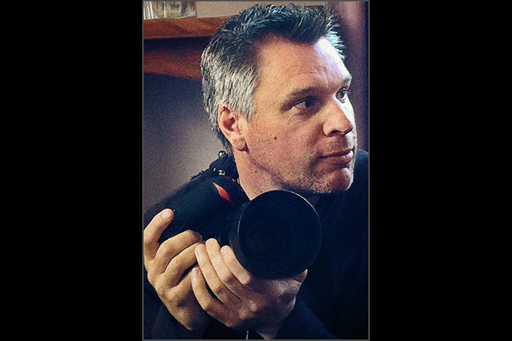 Candid window light portrait of photographer Darren Henderson.