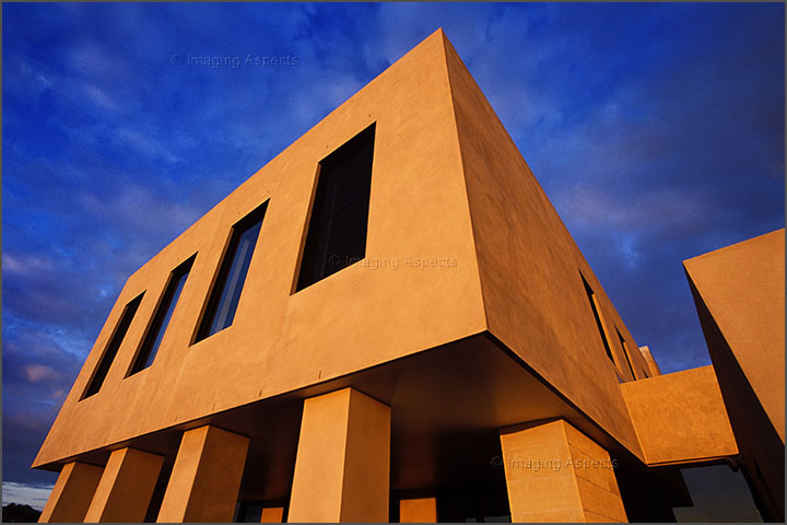 Dramatic camera angle of a sunset lit architect designed residential exterior in Brighton, Victoria.
